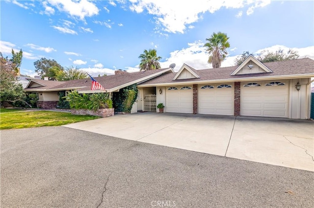 single story home with a garage and a front lawn