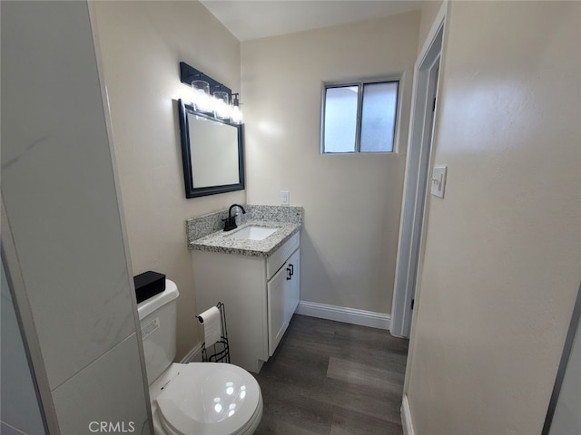 bathroom with vanity, hardwood / wood-style floors, and toilet