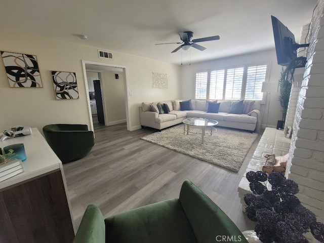 living room featuring hardwood / wood-style flooring and ceiling fan