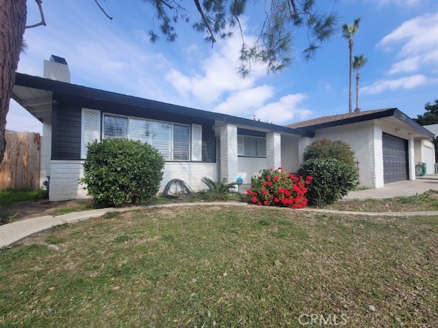 3516 Eisenhower Ave, Bakersfield, CA 93309 - ranch-style house with a garage and a front yard