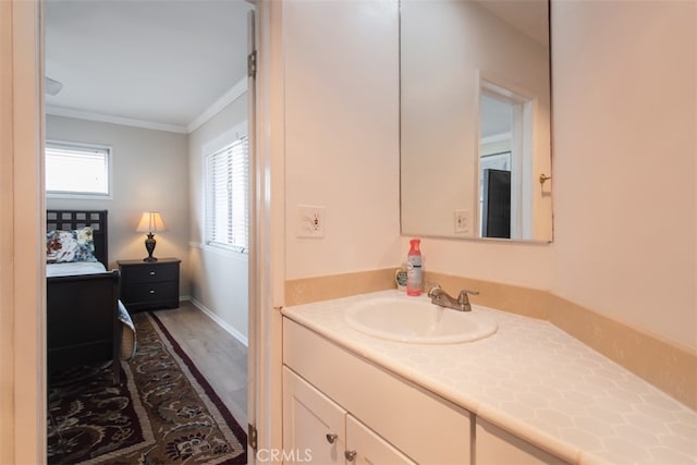 bathroom featuring vanity, hardwood / wood-style floors, and ornamental molding