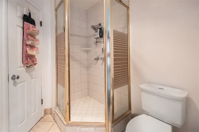 bathroom with tile patterned floors, toilet, and walk in shower