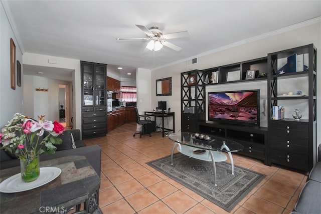 living room featuring tile patterned flooring, crown molding, and ceiling fan