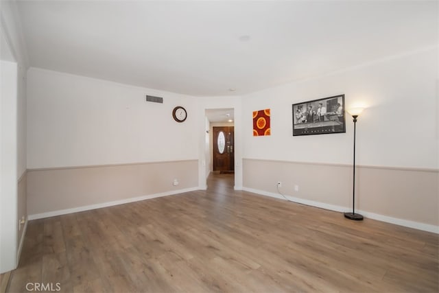 unfurnished room with hardwood / wood-style flooring