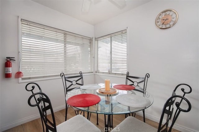 dining space with ceiling fan and light hardwood / wood-style floors