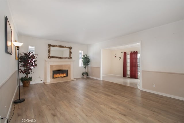 unfurnished living room featuring a fireplace and light wood-type flooring