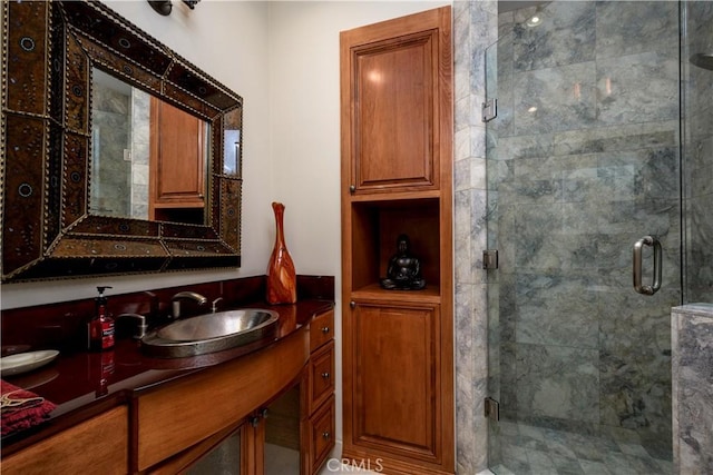 bathroom featuring vanity and a shower with shower door