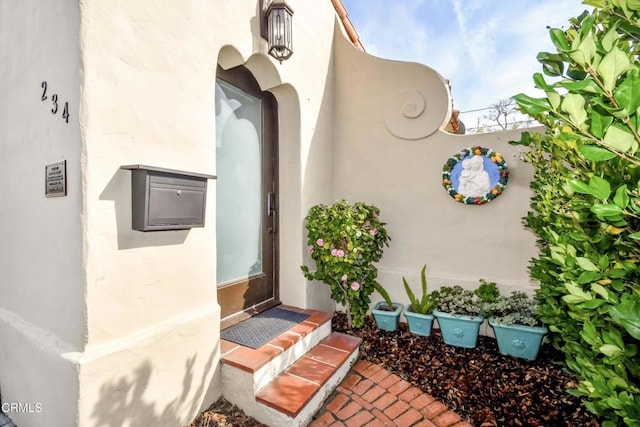 property entrance with stucco siding