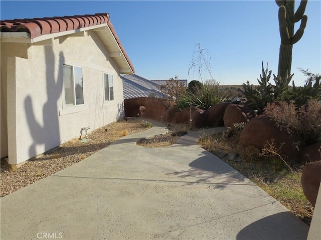 view of property exterior featuring a patio