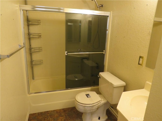 full bathroom with bath / shower combo with glass door, vanity, and toilet