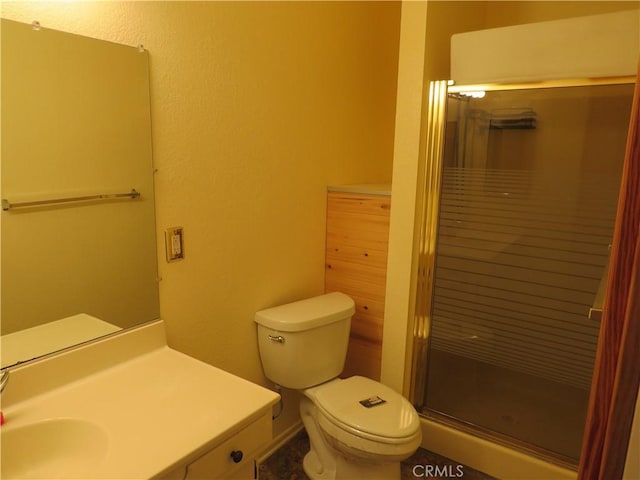 bathroom featuring vanity, toilet, and an enclosed shower