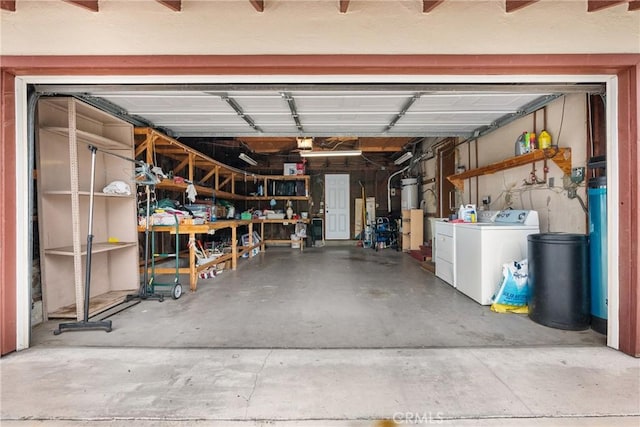 garage featuring water heater and washer and dryer