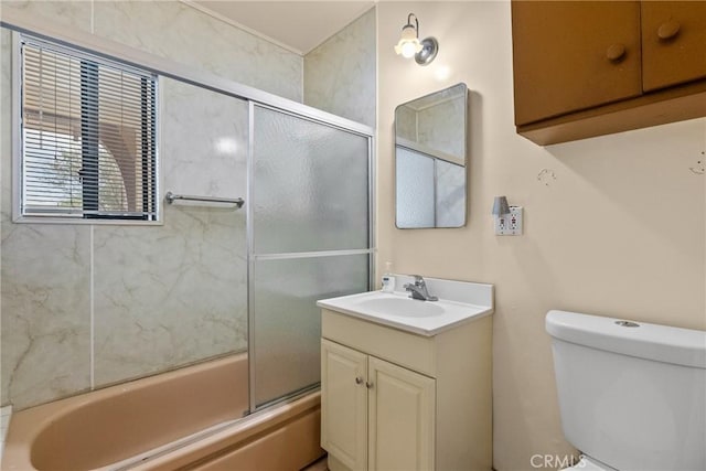 full bathroom featuring bath / shower combo with glass door, vanity, and toilet