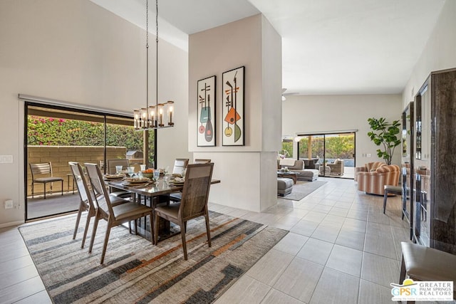 tiled dining room featuring high vaulted ceiling and a chandelier