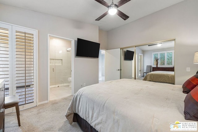 bedroom with ensuite bathroom, light carpet, and ceiling fan