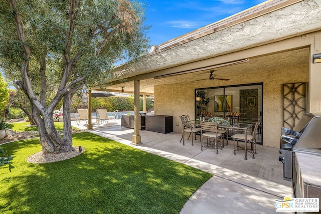 view of yard with ceiling fan, area for grilling, an outdoor living space, and a patio area