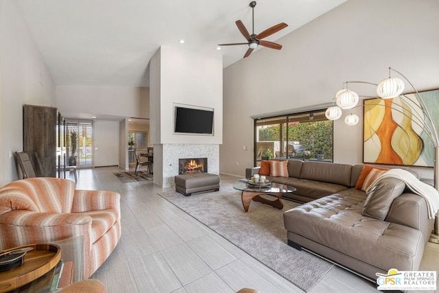 living room featuring ceiling fan, a wealth of natural light, and high vaulted ceiling