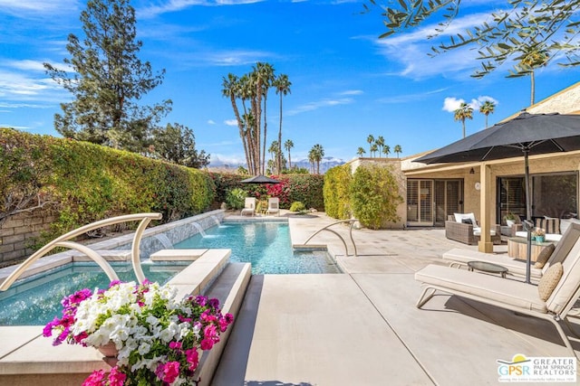 view of swimming pool with an outdoor living space, an in ground hot tub, pool water feature, and a patio