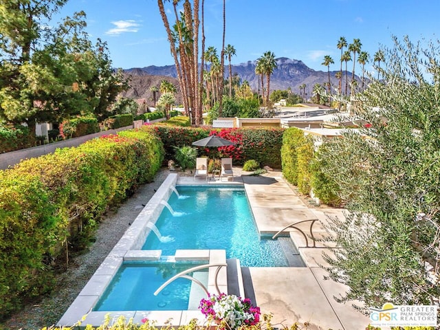 view of pool featuring a patio, a mountain view, and pool water feature