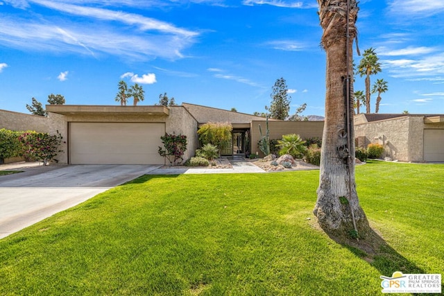 ranch-style house featuring a garage and a front lawn