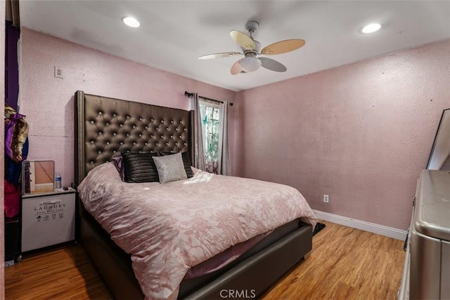 bedroom with ceiling fan and light wood-type flooring