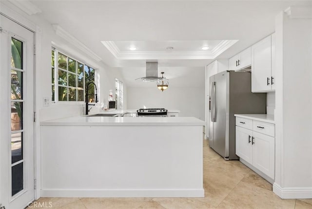 kitchen with island range hood, a raised ceiling, white cabinetry, kitchen peninsula, and stainless steel appliances