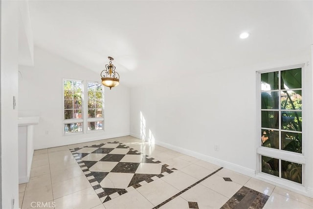 interior space with lofted ceiling and light tile patterned floors