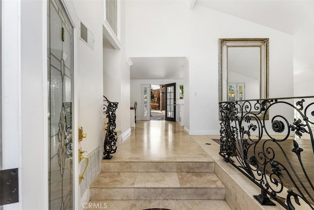 foyer entrance with high vaulted ceiling