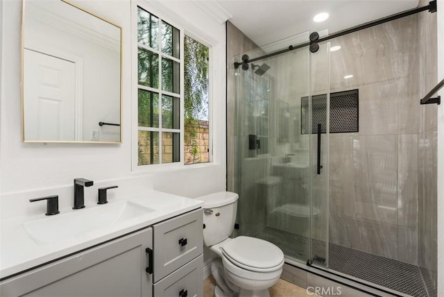 bathroom with vanity, toilet, and walk in shower