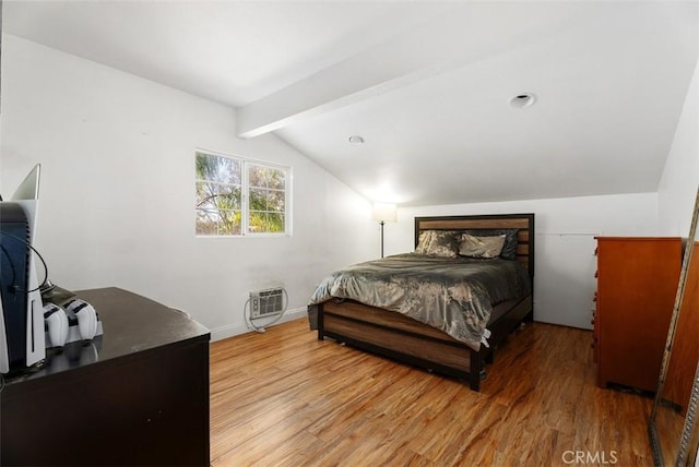 bedroom featuring light hardwood / wood-style floors and lofted ceiling with beams