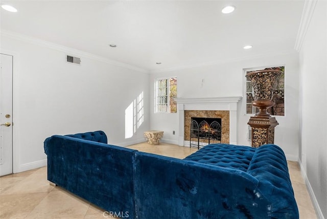 living room featuring crown molding and a premium fireplace