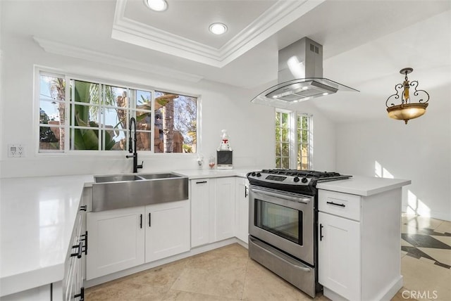 kitchen featuring island range hood, sink, white cabinets, kitchen peninsula, and stainless steel gas range