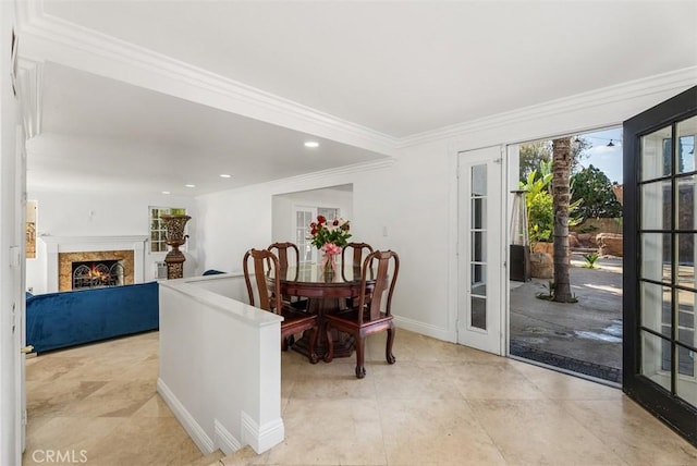 tiled dining area with crown molding and french doors