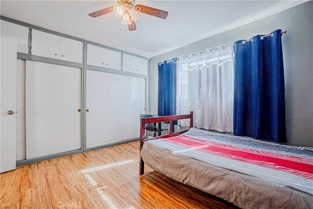 bedroom with ceiling fan and light hardwood / wood-style floors