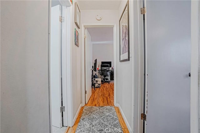 corridor with light hardwood / wood-style floors