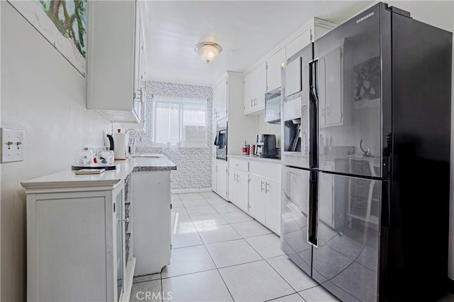 kitchen featuring white cabinetry, black refrigerator with ice dispenser, and light tile patterned floors