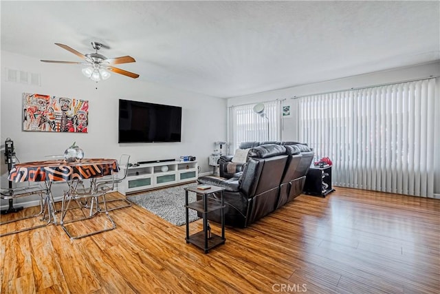 living room featuring ceiling fan and wood-type flooring