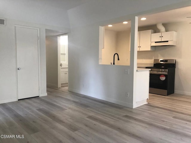 kitchen with white cabinetry, light hardwood / wood-style flooring, and stainless steel electric range