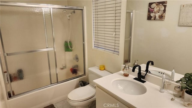 full bathroom with vanity, shower / bath combination with glass door, and toilet