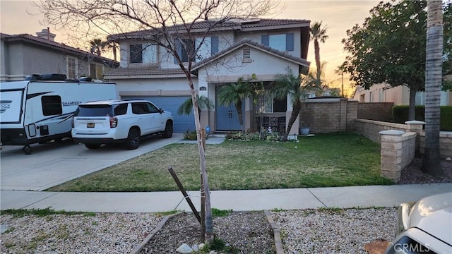 view of front of house featuring an attached garage, driveway, a tiled roof, stucco siding, and a front lawn