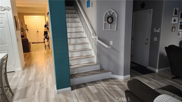 stairway featuring wood-type flooring