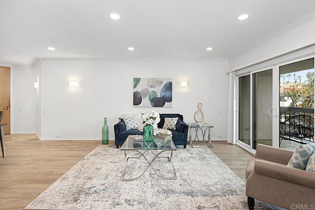 living room with ornamental molding and light wood-type flooring