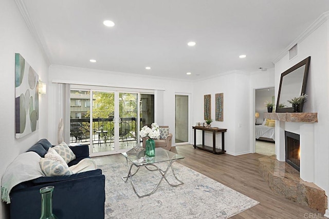 living room with hardwood / wood-style flooring and ornamental molding