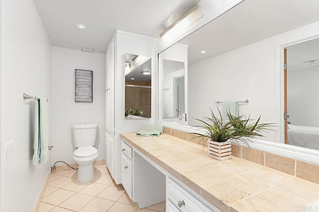 bathroom featuring vanity, toilet, and tile patterned flooring