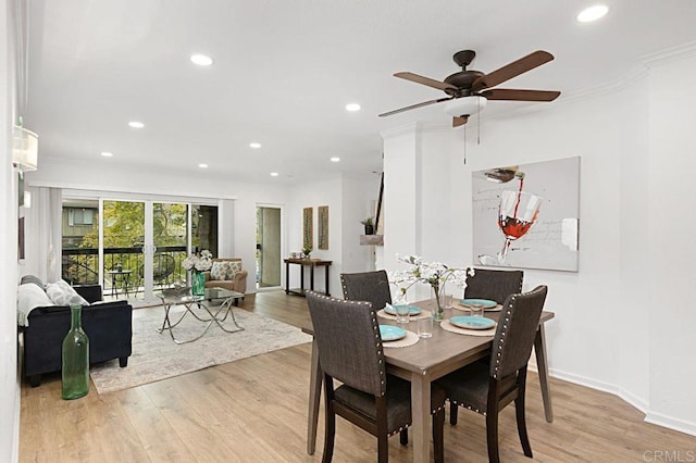 dining room with ornamental molding, ceiling fan, and light hardwood / wood-style floors