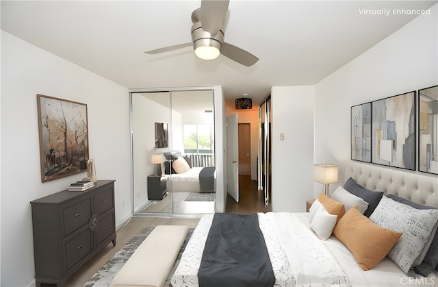 bedroom with hardwood / wood-style flooring, ceiling fan, and a closet