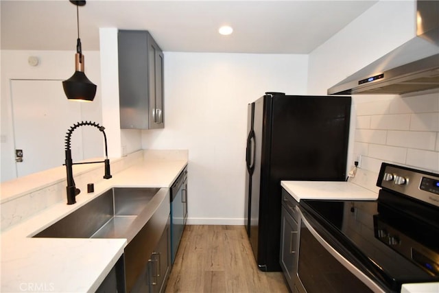 kitchen with sink, stainless steel range with electric cooktop, hanging light fixtures, black dishwasher, and exhaust hood