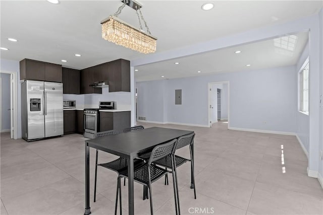 dining room featuring light tile patterned floors, electric panel, baseboards, and recessed lighting