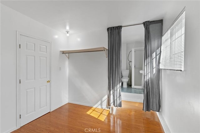 stairway with wood finished floors and baseboards