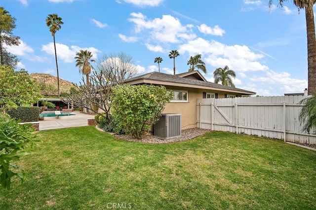 view of yard featuring a patio, a fenced backyard, and central air condition unit